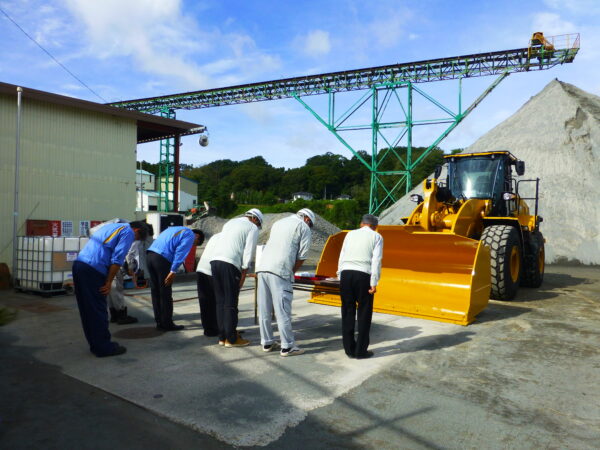 佐久砕石工場納車式。みんなで安全祈願をしている様子の画像。